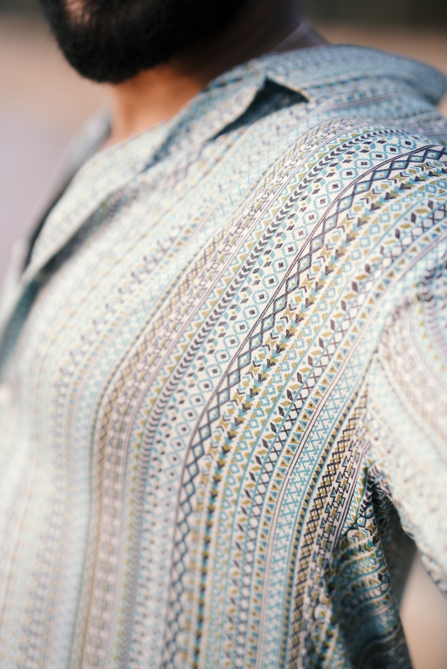 A close-up of the fabric from Mod Mavens' light green and aqua blue boho-patterned half-sleeve shirt, showcasing the intricate, detailed print and soft texture. The zoomed view emphasizes the high-quality material and craftsmanship of the design.