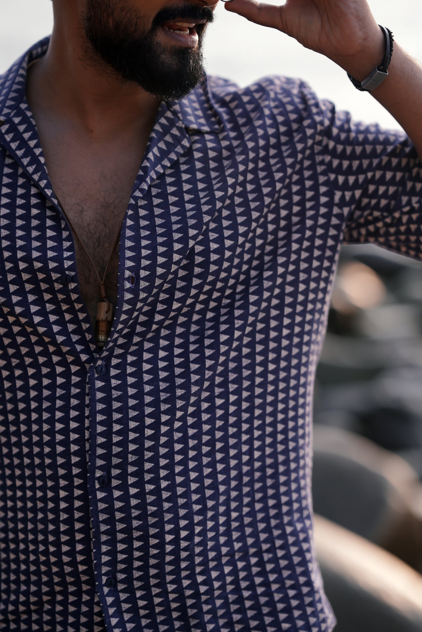 **ALT TEXT:**
A close-up view of a navy blue half-sleeve shirt with a white triangle print from Mod Mavens' new menswear collection. The detailed zoom highlights the soft fabric texture and the crisp geometric pattern, showcasing the shirt's high-quality design and craftsmanship.