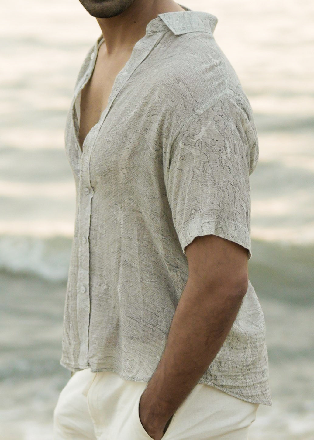 Close up view showcasing the effortlessly stylish look with a Mod Maven grey Dobby cotton marble printed half-sleeve shirt enhancing the fabric texture and pattern, showcasing the laid-back elegance of the Mod Maven brand.
