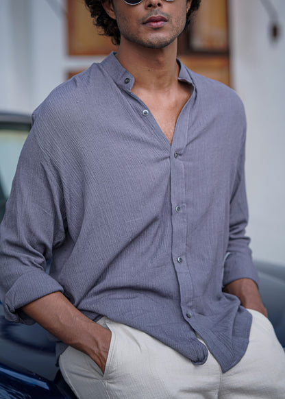 Close up view of Mod Maven Lilac Grey Crushed Cotton Full Sleeve Shirt paired with Off-White Comfortable Fit Pants. Model sitting on a vintage dark blue car.